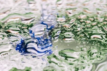Abstract springtender background texture with wet window, Blurred rain drops, drops of water on...
