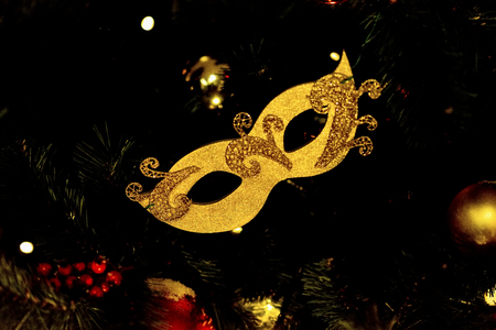 Golden carnival mask on dark background. Festive occasions concept, holiday, Christmas, New Year backdropの写真素材
