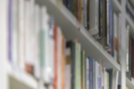 Abstract blurred books, manuals and textbooks on bookshelves