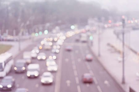 Auto, city street lights and traffic jams. Abstract blurred light background of urban street evening traffic with bokeh lightsの写真素材