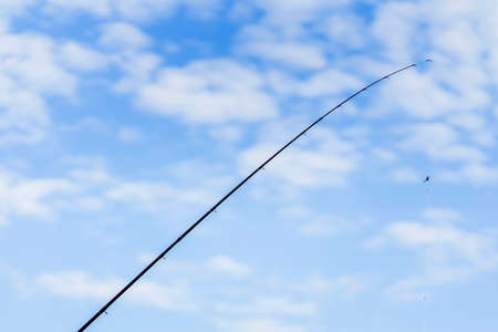 Fishing rod, blue sky, white clouds, Copy spaceの写真素材