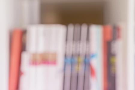 Abstract blurred books, manuals and textbooks, bookshelves with books, library or book store, light backdrop. Concept of learning, school, back to school, studyの写真素材
