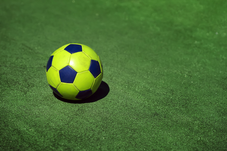 Bright soccer football ball on background of green grass of stadium training, playground, copy space, sport modern backgroundの写真素材