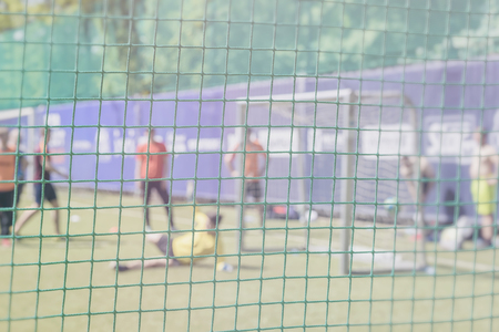 Fight for a soccer ball at the sports gate. Football training on sports field. Soccer school. Sportsmen, football players on Sports training. Football outdoor stadium. Blurred image for Backgroundの写真素材