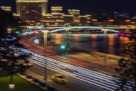 Abstract bright blurred colorful background of urban street night traffic with light trails on motorway highway. Auto, city street lights, speed, transportation conceptの写真素材