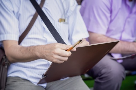 Hands of a street drawing artist with a tablet, a real urban sceneの写真素材