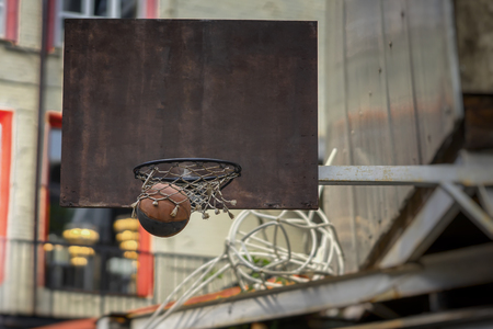 Street basketball game. Basketball shield, ball going through basket. Concept of sport, hit accuracy, active lifestyleの写真素材