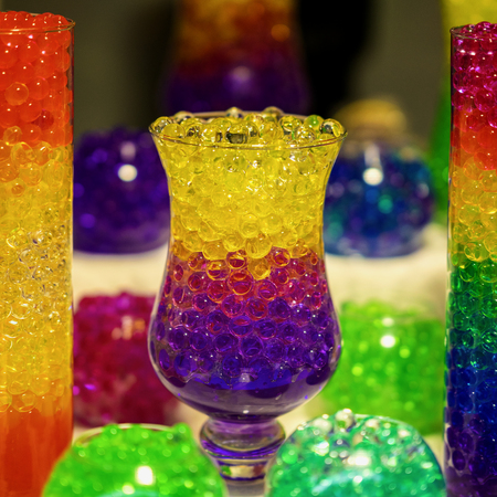 Glass vase with a absorbent balls of hydrogel, bright colored colorsの写真素材