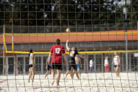 Group of young friends playing beach volleyball, summer day, selectiv focus. Blurred background, healthy lifestyle conceptの写真素材