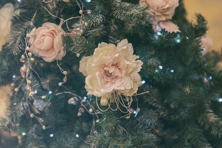 Festive christmas tree with decorations, christmas flowers, light garlands. Selective focus. Winter holiday, Happy New Yearの写真素材