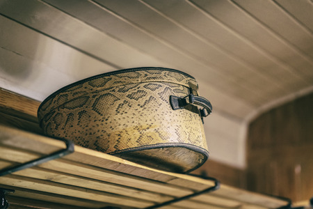 Vintage bag suitcase on shelf closeup. Absract vintage backgroundの写真素材