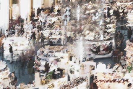Abstract blurred large crowd at a trade fair, unrecognizable people, shopping. For backgroundの写真素材