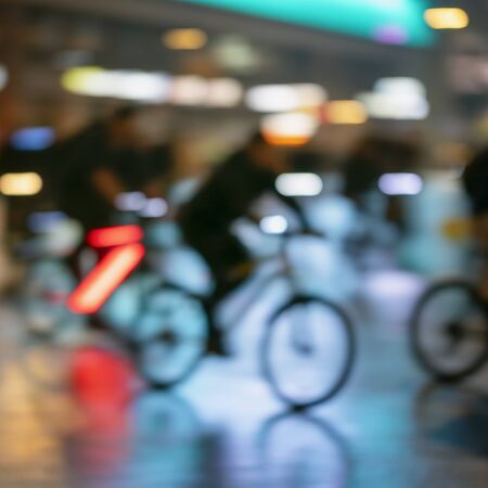 Silhouettes of abstract unrecognizable people, riding bikes, night city, illumination bokeh, motion blur. Healthy lifestyle, leisure activity concept.の写真素材