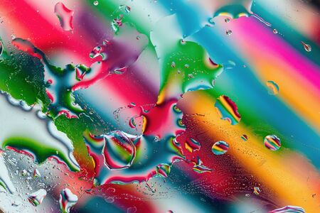 Abstract bright rainbow multicolored background. Colorful macro water bubbles, stains and spotsの写真素材
