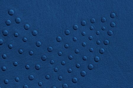 Texture of genuine leather with rivets close-up, blue color, for wallpaper or banner design....