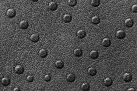 Texture of genuine leather with rivets close-up, gray color, for wallpaper or banner design....
