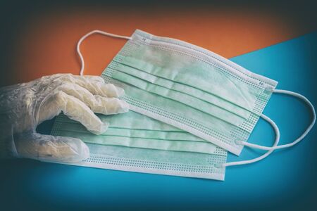 Hand in protective glove and disposable medical masks. Healthcare concept, quarantine, personal...
