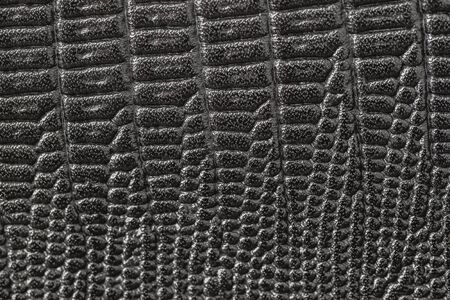 Genuine leather texture backgroundr close-up, embossed under the skin a reptile, grey black color...