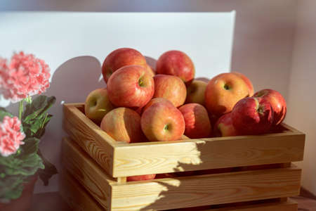 Wooden box with apples at a farmers market.