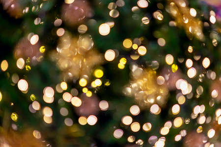 Abstract circular light bokeh, New Year and Christmas festive background of defocused decorated tree...