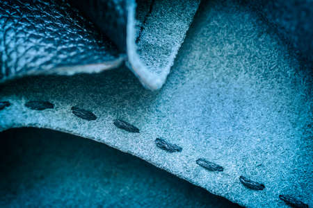 Hand made sewing stitch of leather handbag, coarse thread on leather texture, selective focus. Concept of manufacture of shoes, bags, accessories, furnitureの写真素材