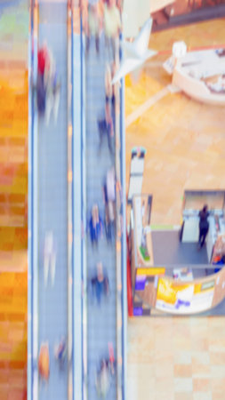 Abstract blurred People in shopping mall, unrecognizable people on escalator, top view. Motion effectの写真素材