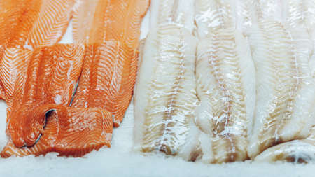 Different Fish fillet on ice, counter of seafood market. Open showcases. Healthy eating concept