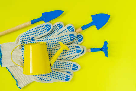 Gardener set, tools for planting, caring for seedlings, work gloves on bright background. Concept of spring, Gardeningの写真素材