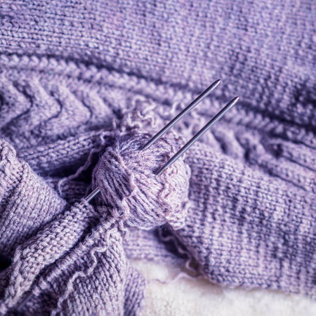 Close up of knitted purple yarn sweater, knitting needle thread for knitting. Knitting, hobby conceptの写真素材