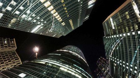 Group of modern skyscrapers in night business city at night. Abstract modern background