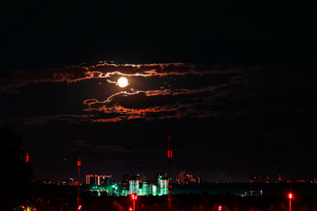 Urban city by dark night on full moon background, urban lights and illuminationの写真素材
