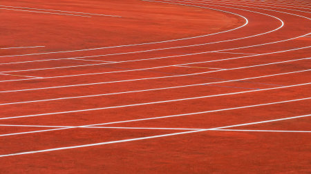 Red running tracks in sport stadium outdoors, background and texture. Sport conceptの写真素材