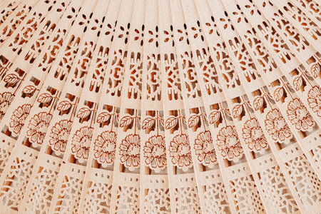 Wooden open fan with pattern. Natural background, textureの写真素材