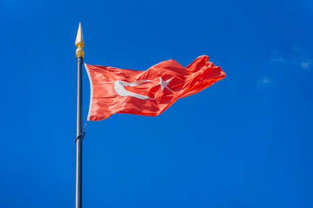 Turkish Flag Waving in the Wind Against a Clear Blue Sky