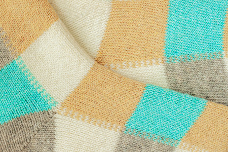 Close-up of colorful craft knitted fabric, textured background