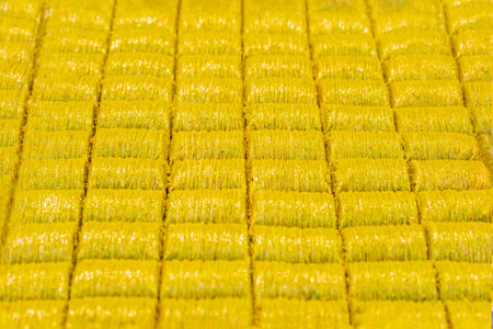 Rows of golden, crispy baklava neatly arranged in a patternの写真素材