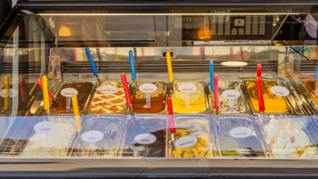 Ice cream display with various colorful flavors in a gelato counter