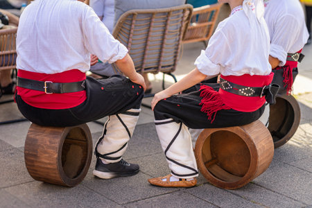Young people from Bulgaria, dressed in traditional clothes, show a national dance number with folk instrumentsの写真素材