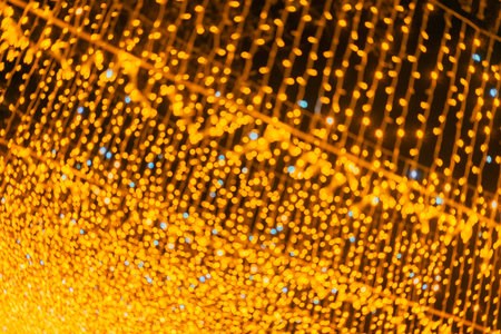 Blurred golden string lights creating festive glowing at night