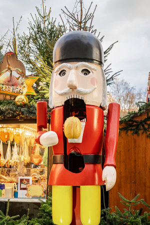 Large decorative nutcracker figure in bright suit standing at a Christmas market. Concept of Christmas, holiday decorationの写真素材