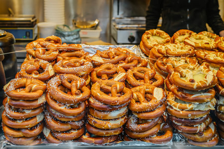 Freshly baked pretzels on display at market stall. Concept of traditional bakery and street foodの写真素材