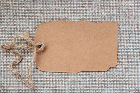 Empty craft paper tag, branding mockup, packaging, promotional design. Kraft paper tag with tied...