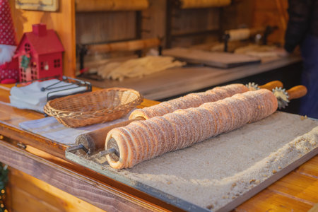 Traditional East Europe Christmas sugar dessert chimney cake, trdlo or trdelnik, sweet aromatic winter seasonal street food with cinnamon and spicesの写真素材