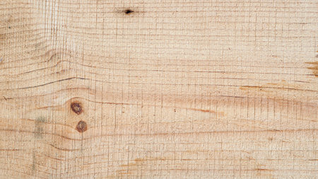 Raw wood surface with visible knots and curved natural grain. Natural background for carpentry, rustic and textured wooden backdrop designの写真素材