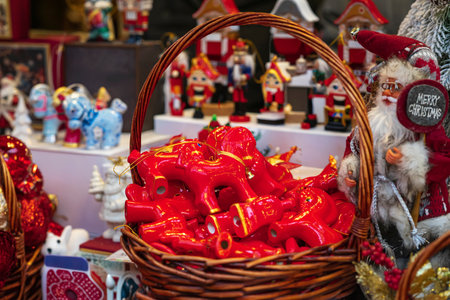 Fair and toys in baskets. Colorful Christmas market stall with handmade red horse ornaments, festive...