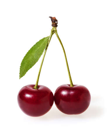 Cherry with green leaf isolated on white backgroundの写真素材