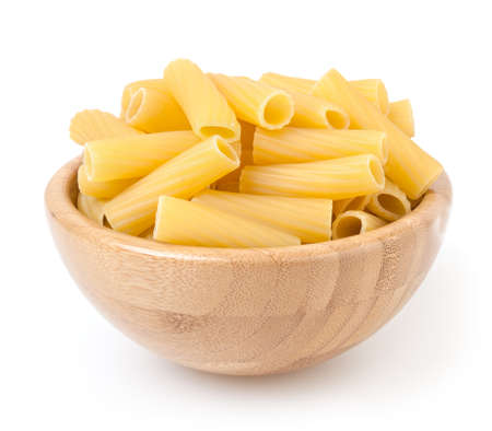 Tortiglioni pasta in wooden bowl isolated on white backgroundの写真素材