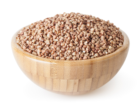 Roasted buckwheat grains in wooden bowl isolated on whiteの写真素材