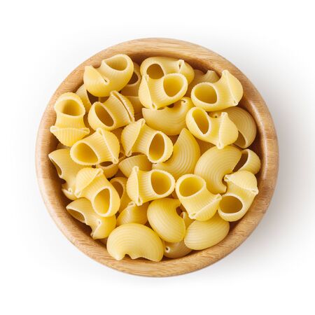 Uncooked pipe rigate pasta in wooden bowl isolated on white backgroundの写真素材