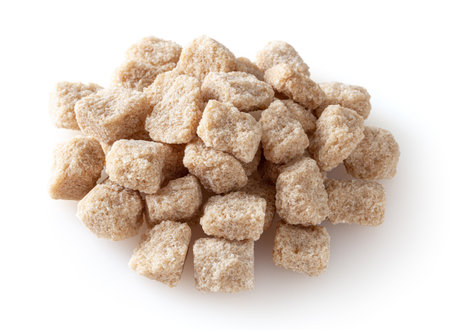 Cubes of brown cane sugar isolated on white backgroundの写真素材